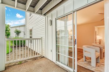 a living room with glass doors and a balcony at The Oliver Apartment Homes, Mississippi, 38654
